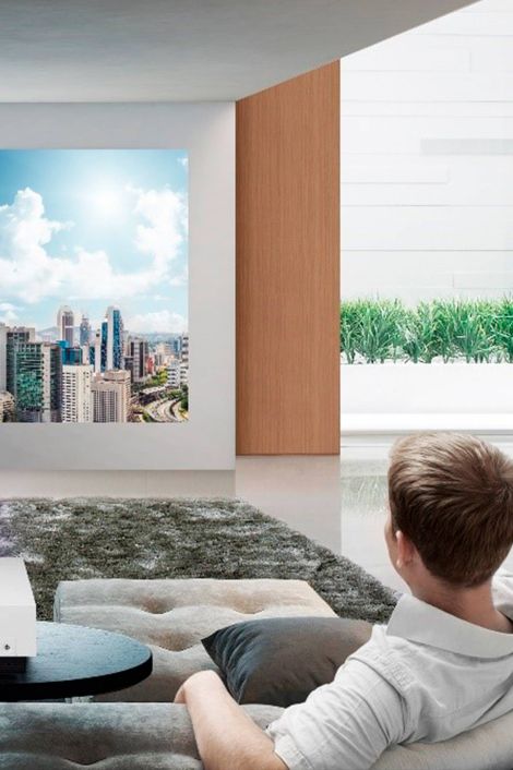 Man watching tv on white wall, samsung technology