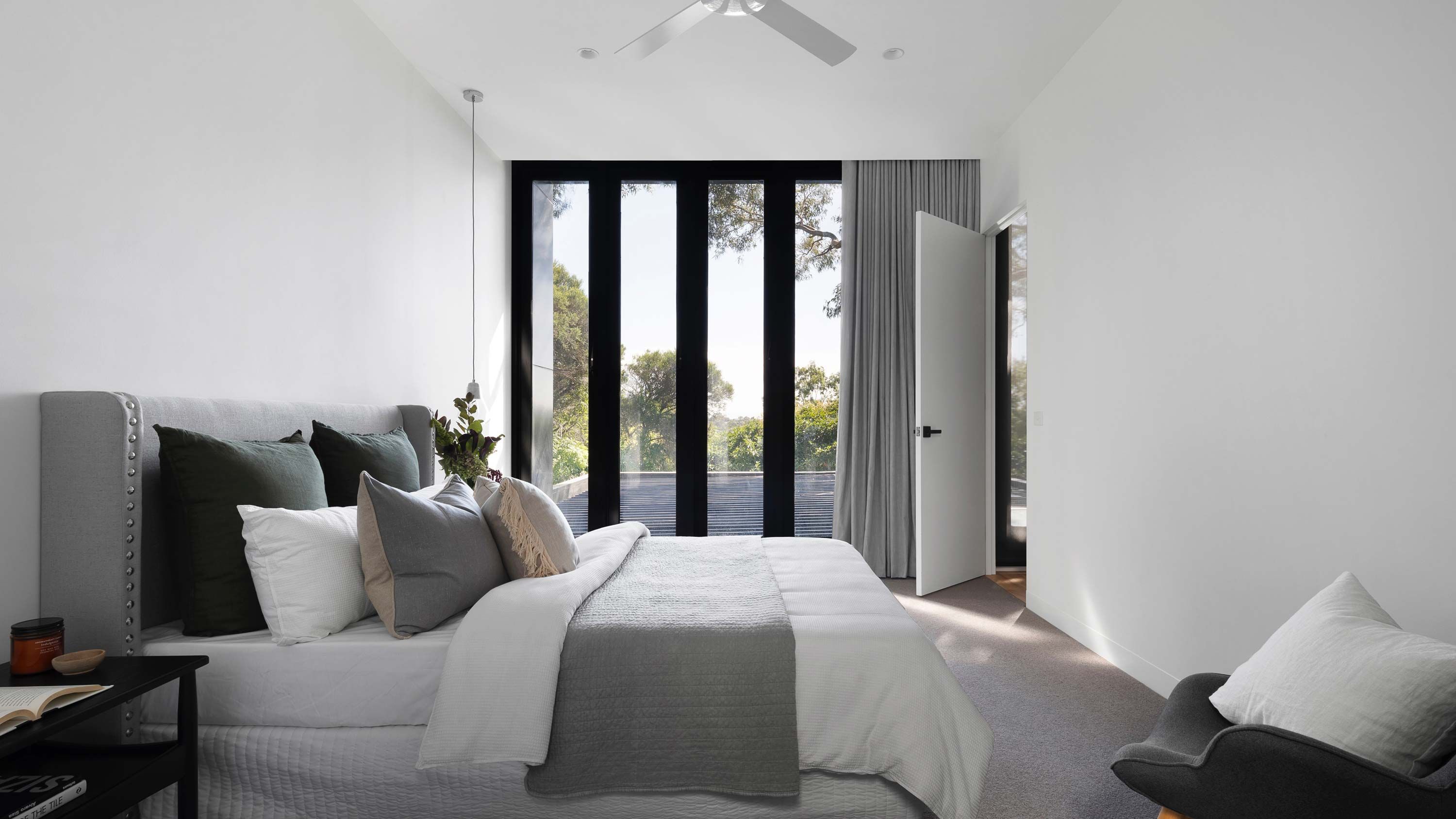 warm toned bedroom with lutron window treatments
