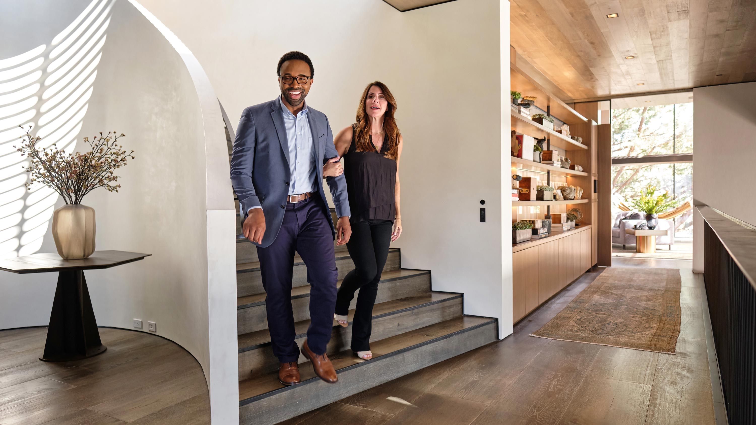 man and woman coming down the stairs